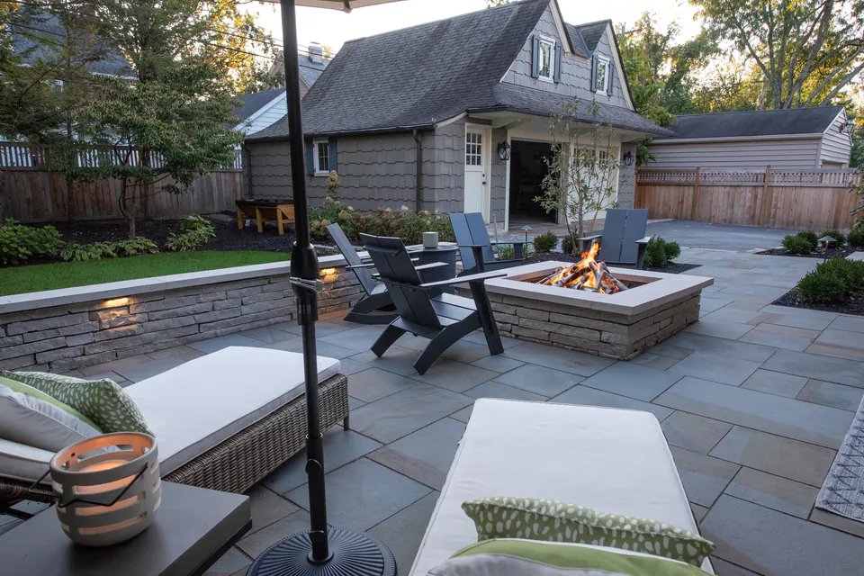 Backyard terrace edge with privacy planting and hardscape transition